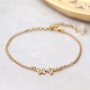 Trendy oorbellen en armbanden met zirkonia bedels en tussenstukken: