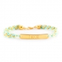 Trendy ketting met halfedelsteen hanger en heel veel macram&eacute; armbandjes! 